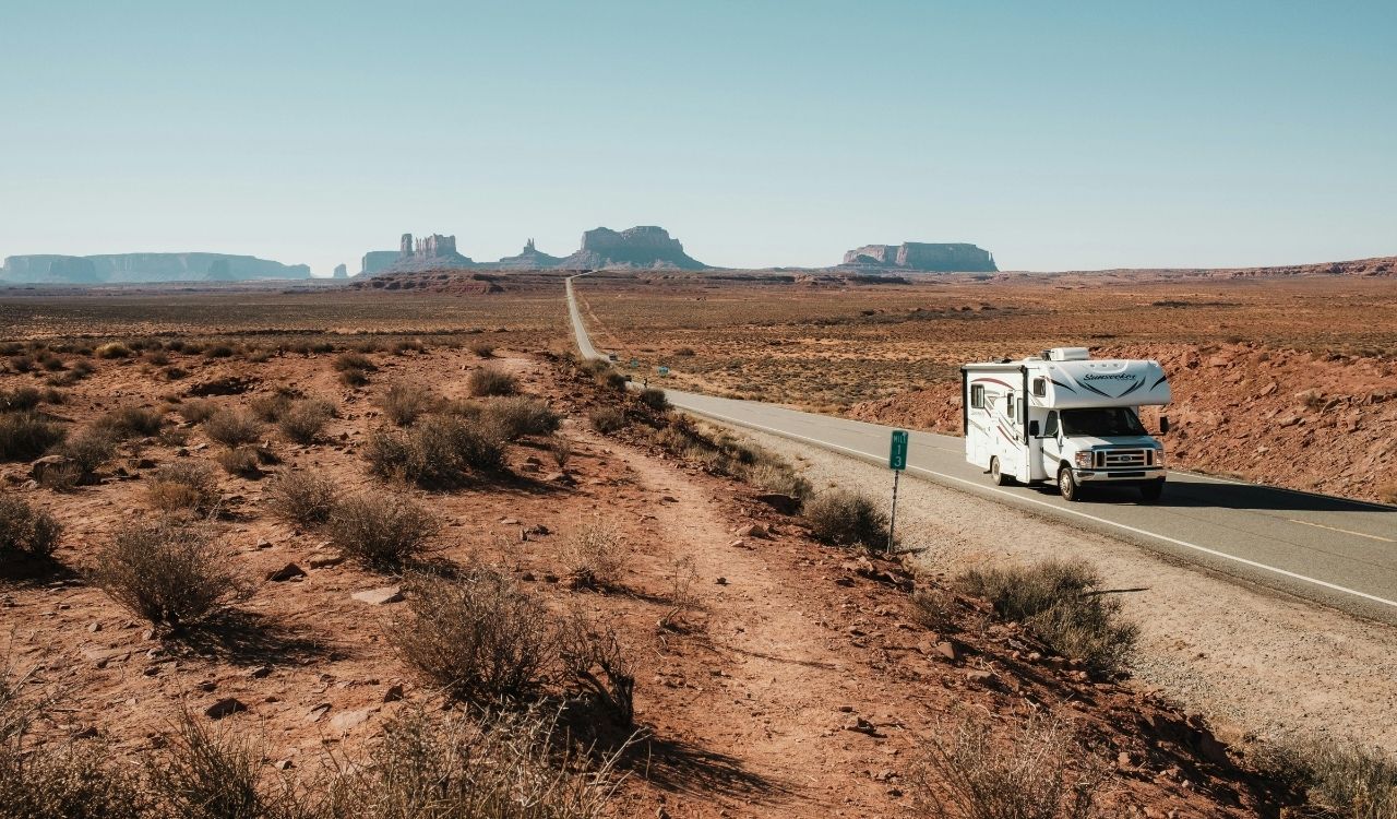 US road trip Camper on Road in Monument Valley in USA